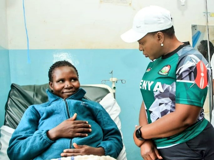 Health Cabinet Secretary Susan Nakhumicha speaks to a patient at a hospital.