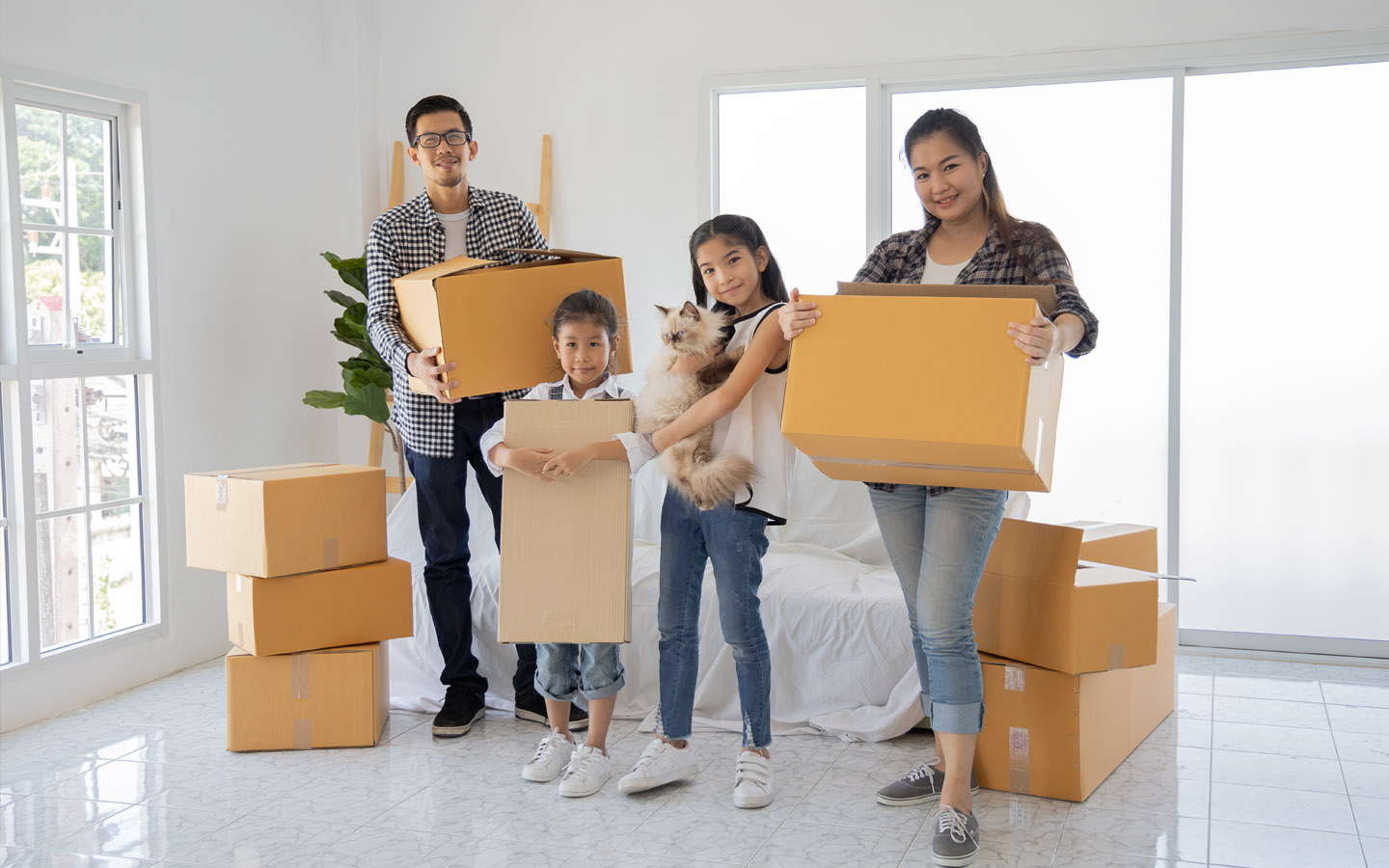 buying a new property: family carrying boxes