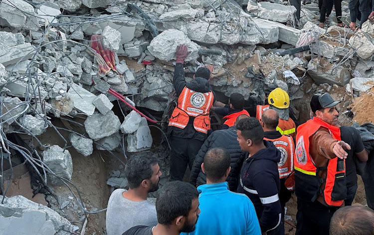 Palestinians search for casualties at the site of an Israeli strike on a house, amid the ongoing conflict between Israel and the Palestinian Islamist group Hamas, in Rafah in the southern Gaza Strip, on December 29 2023. Picture: ARAFAT BARBAKH/REUTERS