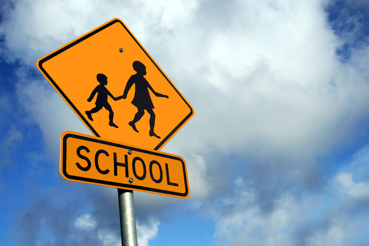 School children crossing kids sign