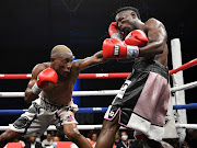 Sibusiso Zingange, left, scores with a jab on his way to dethroning SA junior-lightweight champion Phila Mpontshane in Johannesburg on Thursday night.