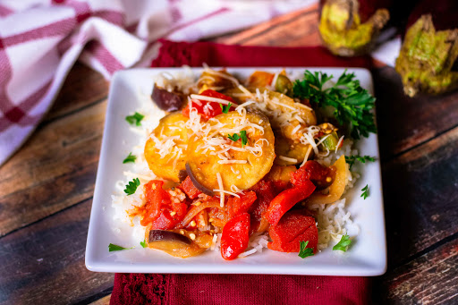 Spicy Stewed Eggplant on a plate over rice.