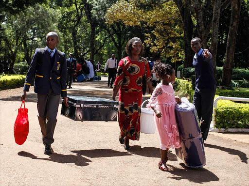 A Form 1 student arrives at his new school on reporting day, January 7.