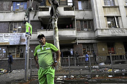 Herman Mashaba in front of a building hijacked more than a decade ago by illegal tenants in the Johannesburg inner city.