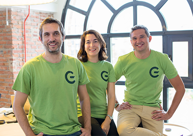 The GreeMko cofounders are wearing matching green shirts with their startups’ logo and smiling at the camera.