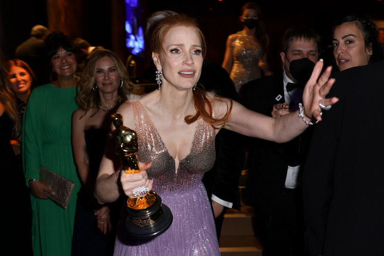 Best Actress Jessica Chastain holds her Oscar for 'The Eyes of Tammy Faye' at the Governors Ball after the 94th Academy Awards in Los Angeles on March 27 2022.