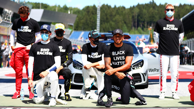 Lewis Hamilton of Great Britain and Mercedes GP, Pierre Gasly of France and Scuderia AlphaTauri and some of the F1 drivers take a knee on the grid in support of the Black Lives Matter movement before the Formula One Grand Prix of Austria at Red Bull Ring on July 5 2020 in Spielberg, Austria.