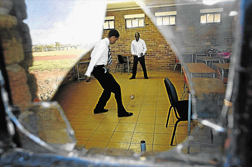 Pupils play soccer inside a classroom at a school in Soweto. While pupils play and learn at school, some teachers are paid to sit at the premises doing nothing day after day