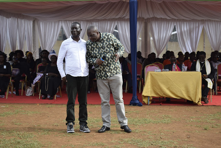 Kasipul MP Ongondo Were and his Nyatike counterpart Tom Odege consult at Agoro Sare primary school during the burial of ex- UASU chairman Muga Kolale in Oyugis on April 21,2023