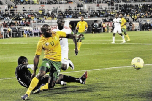 MUZZLED: Bafana Bafana striker Tokelo Rantie is stopped by Congo goalkeeper Chansel Massa during their Afcon 2015 qualifier match at Peter Mokaba Stadium in Polokwane on Wednesday Photo: Philip Maeta/Gallo Images