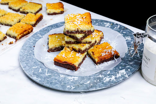 Black Bottomed Coconut Dream Bars cut into squares.