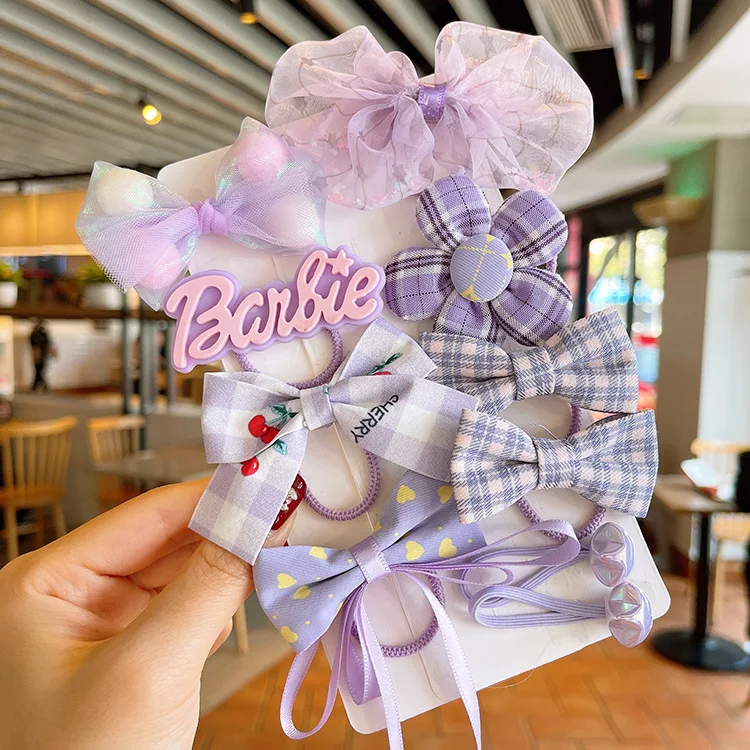 Anneau de cheveux élastique pour bébé avec fleur et nœud en maille. Accessoire adorable et pratique pour les coiffures des petites filles.