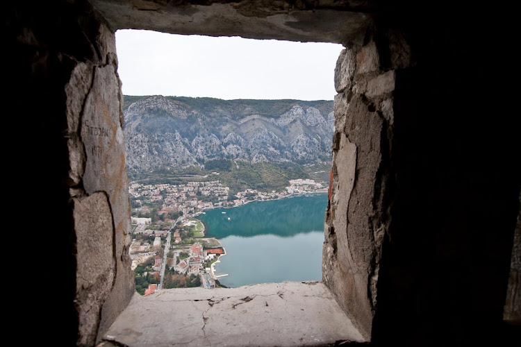 Kotor as seen through a window in the abandoned Castle of San Giovanni (or the Castle of St. John as English-speaking tourists call it).