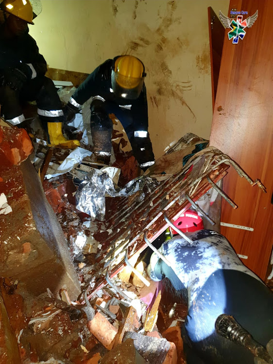 Emergency rescue teams worked for about two hours to rescue a woman in her 70s who had been trapped under rubble after her home collapsed in torrential rains. Her son, who was in the next room, died as a result of his injuries.