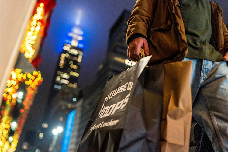 A man carries his shopping bags during the holiday season in New York, the US, December 10 2023. Picture: EDUARDO MUNOZ/REUTERS