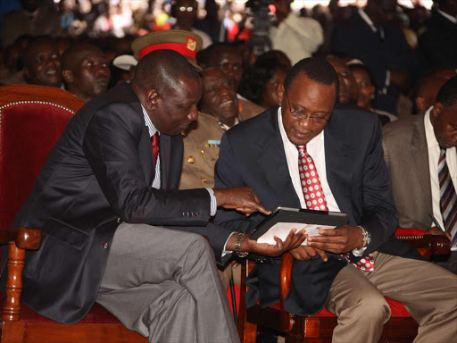 President Uhuru Kenyatta and Deputy President William Ruto use an iPad during the official launch of the Inua Jamii Cash Programmes . file