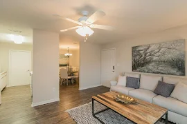 Furnished living room with wood-inspired flooring and a ceiling fan