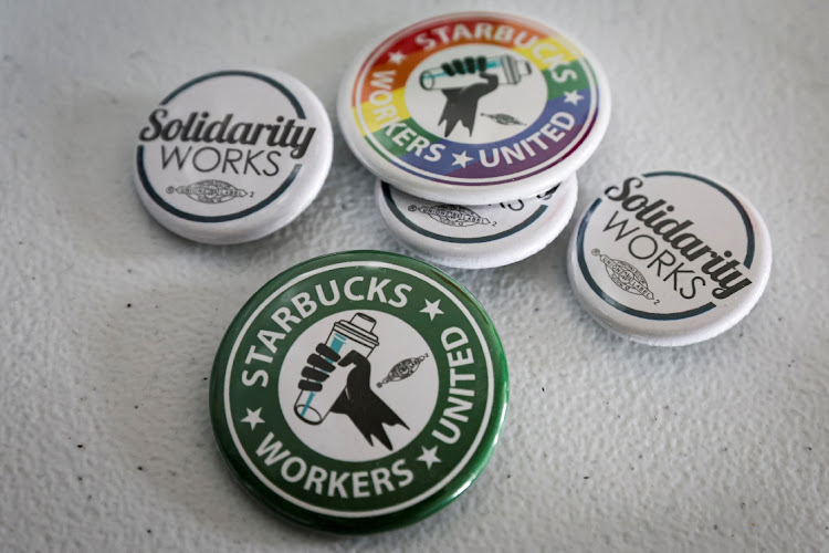 Badges showing support for a Starbucks Union are seen at the Workers United offices in Buffalo, New York, US, February 23 2022. File picture: REUTERS/BRENDAN MCDERMID.