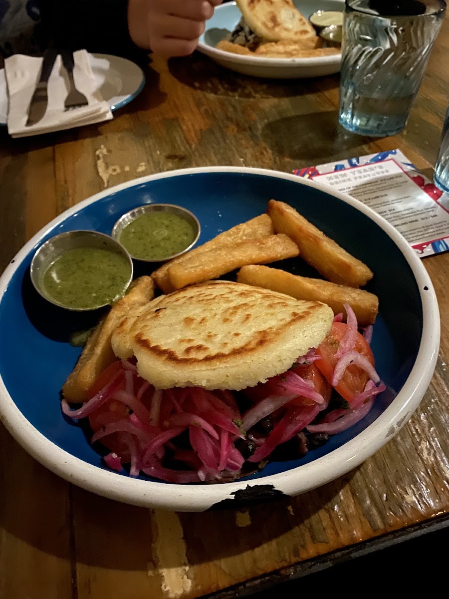 Vegan black bean and sweet potato arepa with yuca fries