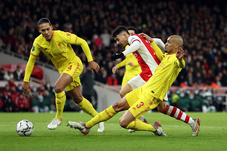 Liverpool's Virgil van Dijk and Fabinho in action with Arsenal's Gabriel Martinelli