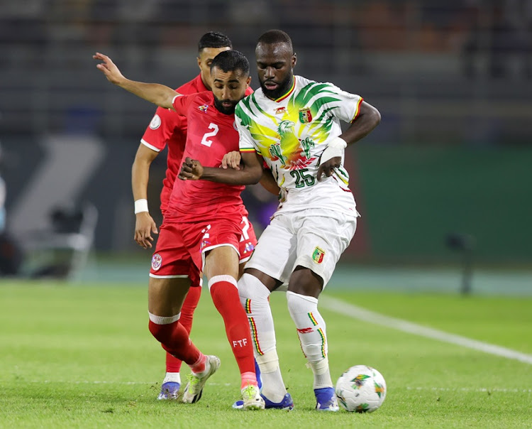 Lassine Sinayoko of Mali challenged by Ali El-Abdi of Tunisia during their Africa Cup of Nations clash at Amadou Gon Coulibaly Stadium in Korhogo.