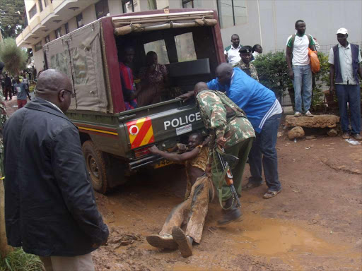 Booze is back: Security officers during a crackdown on illicit alcohol in Eldoret town in October last year. Alcohol use dropped 70 per cent after the crackdown.