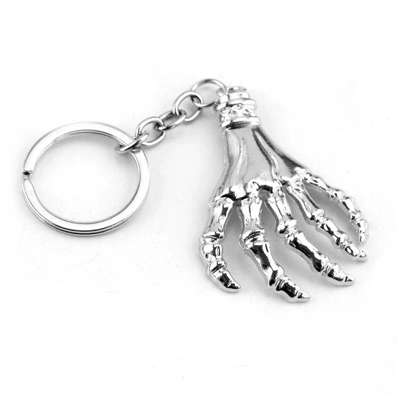 Porte-clés créatif avec pendentif tête de mort et paume, cadeau original et stylé, accessoire parfait pour clés, sacs, un design unique et moderne.