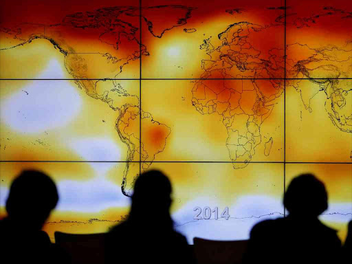 Participants are seen in silhouette as they look at a screen showing a world map with climate anomalies during the World Climate Change Conference 2015 (COP21) at Le Bourget, near Paris, France, December 8, 2015. /REUTERS