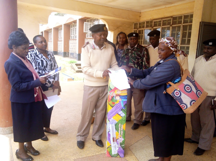 National Fund for the Disabled of Kenya chairperson Prof Julia Ojiambo and Lari deputy county commissioner Samuel Kariuki.