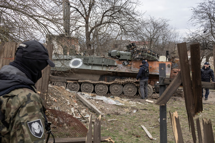 Ukrainian servicemen check a damaged Russian military vehicle, as Russia's invasion of Ukraine continues, in the village of Yahidne, near to Chernihiv, Ukraine, April 6, 2022.