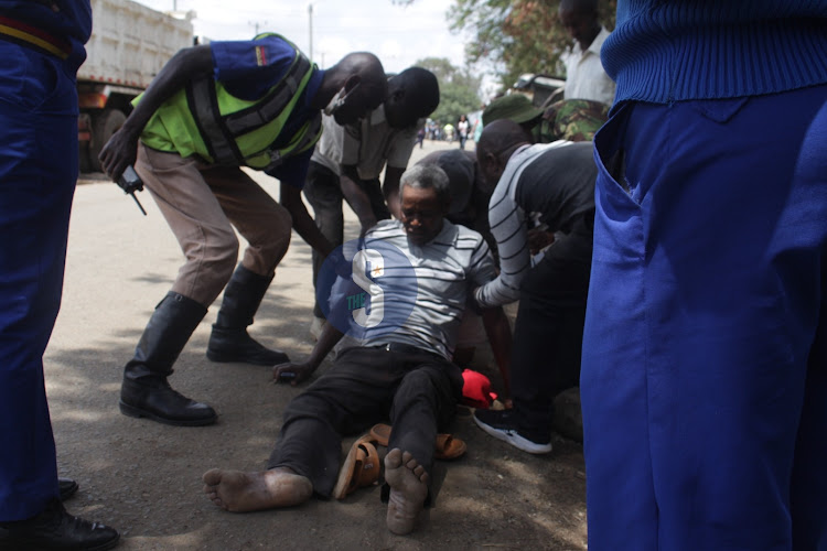 A man injured during an Azimio protest getting help on March 20, 2023.