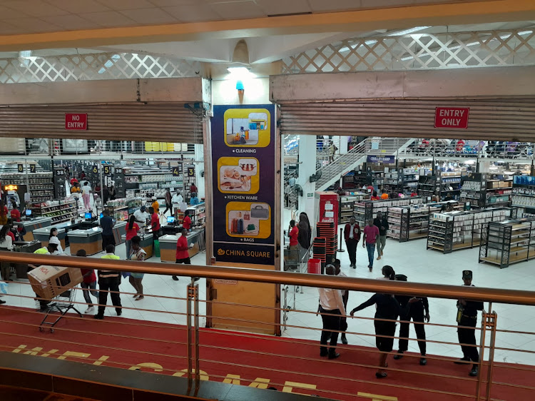 Customers buying goods at China Square mall.