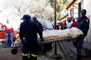 Relatives and friends could not hold their tears as police officers carry the bodies of Jabulani Ndima and Peggy Mvelwa into a pathology van after Ndima allegedly murdered Mvelwa before turning the gun on himself in Khutsong Hostel.