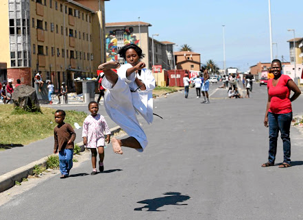 HANDY DAN Karate student Ncumisa Plum, 20, shows off her karate skills on the streets of Langa, as her proud mother Alicia Blom, right, looks on.