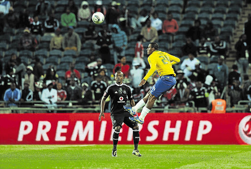 Franklin Cale outjumps a bemused Ruben Cloete during the Absa Premiership match between Orlando Pirates and Mamelodi Sundowns at Orlando Stadium last week. Sundowns have shifted their home base from Lucas Moripe stadium to Loftus Picture: GALLO IMAGES
