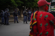 Armed police keep guard outside the courthouse.