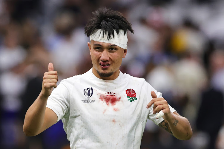 Marcus Smith of England celebrates victory, bloodied and bandaged, after the Rugby World Cup quarterfinal against Fiji at Stade Velodrome in Marseille on Sunday.