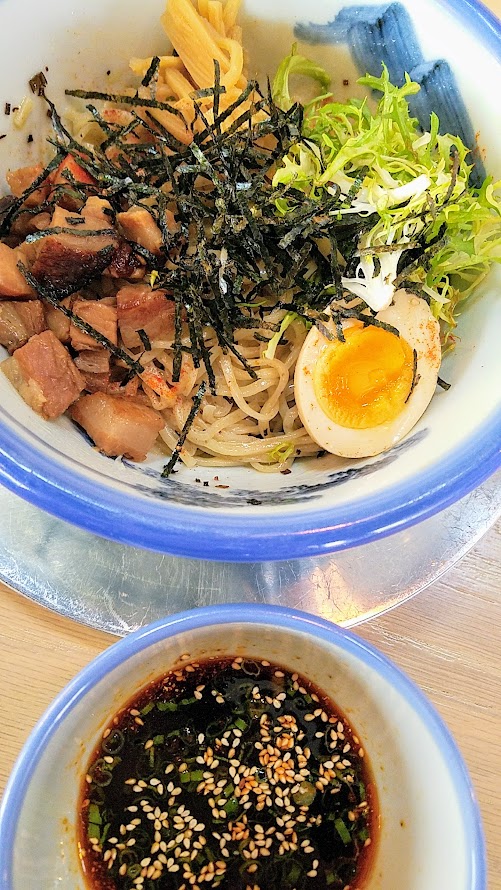 Afuri PDX Tsukemen, a cold ramen noodle dish with tsuyu dipping sauce. This is Spicy Tsukemen with spicy soy tsuyu, chashu pork, seasoend egg, seasoned bamboo shoots, endive, nori seaweed, scallion, sesame, chili powder