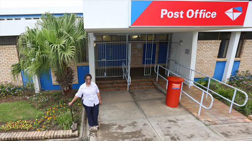 STAMP OF APPROVAL: Gonubie Post Office branch manager Thami Lugayeni is thrilled that the suburb's residents including Rotarians and a group of community activists called Nubians, have spruced up the flower beds which she has committed to keeping neat and weed free. Picture: STEPHANIE LLOYD