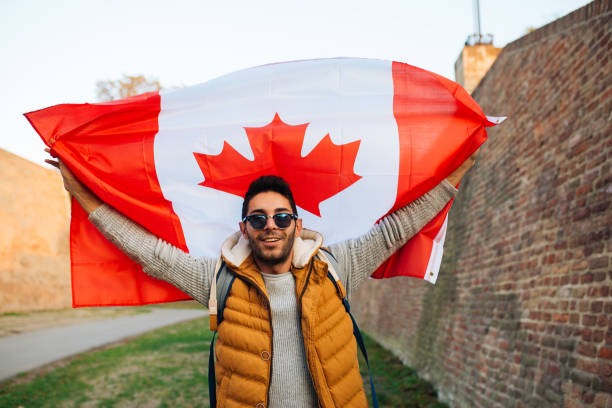 Person holding the Canadian flag