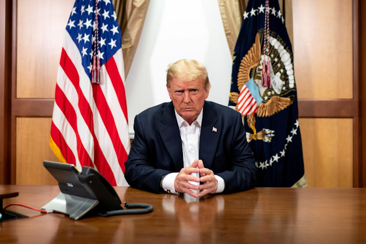 US President Donald Trump participates in a phone call with vice-president Mike Pence, secretary of state Mike Pompeo, and chairman of the joint chiefs of staff General Mark Milley in his conference room at Walter Reed National Military Medical Center in Bethesda, Maryland.