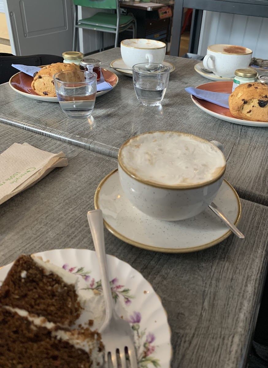 Gluten free carrot cake in the foreground. Delicious coffee with cream. Scone in the background not gluten free but my non-celiac friends loved them!