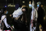 People who have been evacuated from Afghanistan arrive at Tirana International Airport, after Taliban insurgents entered Afghanistan's capital Kabul, in Tirana, Albania, August 27, 2021.