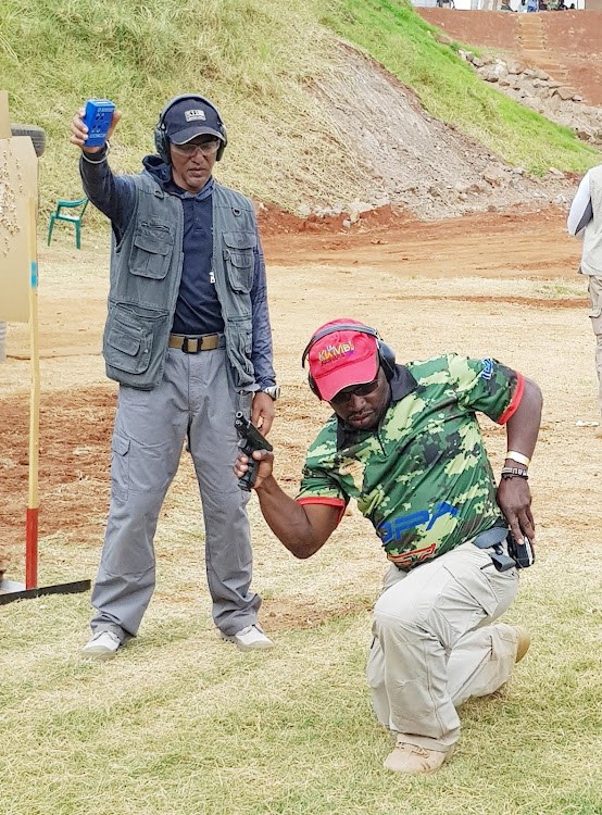 Shooter Sammy Onyango (R) and safety officer Abdulkarim Rahim (L) in a past action at Kirigiti Range.