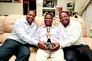 POSITIVE:
         Joseph Shabalala,  centre, his son Sibongiseni, left, and Xolani Majozi  with a model of the awards  
      PHOTO: SUPPLIED