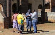 File photo: Investigators interview locals in the township of Vosloorus, where soccer captain Senzo Meyiwa was shot dead by intruders.  REUTERS/Siphiwe Sibeko