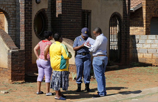 File photo: Investigators interview locals in the township of Vosloorus, where soccer captain Senzo Meyiwa was shot dead by intruders. REUTERS/Siphiwe Sibeko