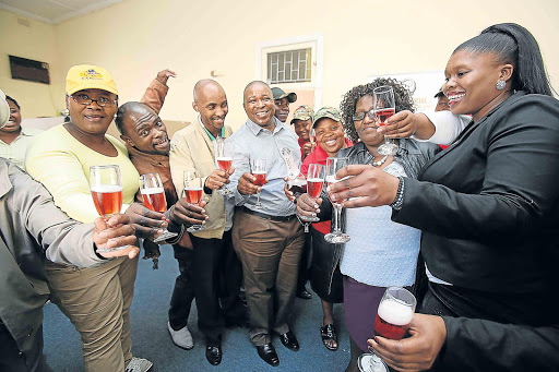 MILESTONE EVENT: Buffalo City Metro councillor Siyabonga Jabavu, third left, Unemployed Workers’ Union of South Africa president Jabu Ntus, fourth left, and other officials toast the union’s 30th anniversary in East London, yesterday Picture: MARK ANDREWS