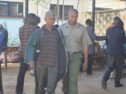 Kevin Simiyu is led outside Bungoma law court he was jailed for fifteen months on Thursday, March, 2017. /JOHN NALIANYA