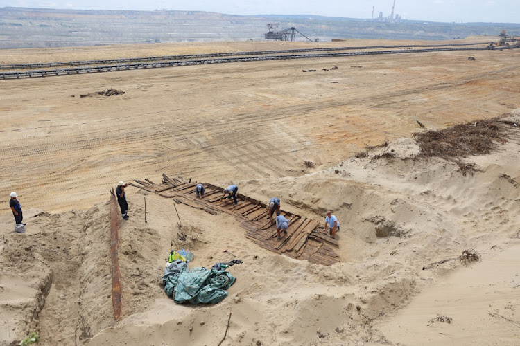 Archaeologists excavate the hull of a wooden ship, an ancient Roman flat-hulled riverine vessel at the ancient city of Viminacium, near Kostolac, Serbia, August 2, 2023.